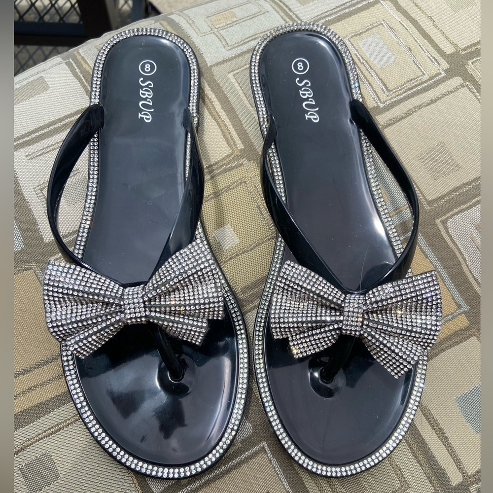 New never worn bling with bow sandals.